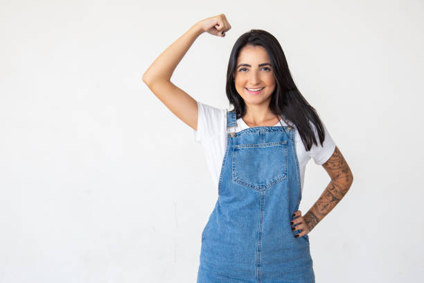 istock Smiling strong woman with raised hand 1181458259