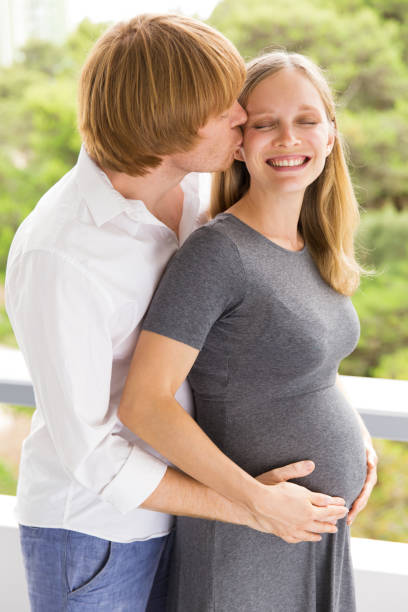 istock Expectant parents holding belly 1181458300