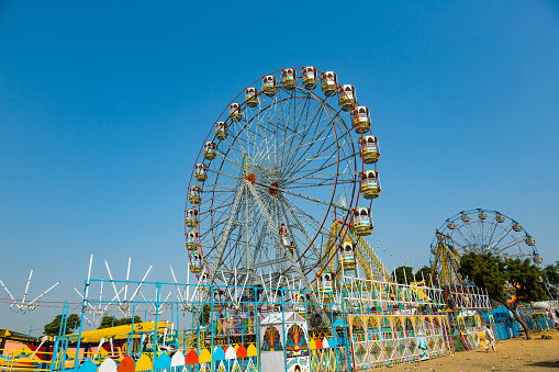 PUSHKAR, INDIA - NOVEMBER 20, 2012: Colorful Ferris Wheel in Pushkar. Things to do in Pushkar