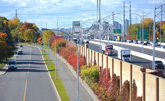 Transportation...This interesting shot taken in October 2019, shows the new Champlain Bridge in the distance, just opened to traffic this past summer, [July 2019], The bridge crosses the St.Lawrence River at Montreal and is considered to be the busiest in Canada. The view here, is from an overpass in the South Shore community of Brossard, and emphasizes a tall, 