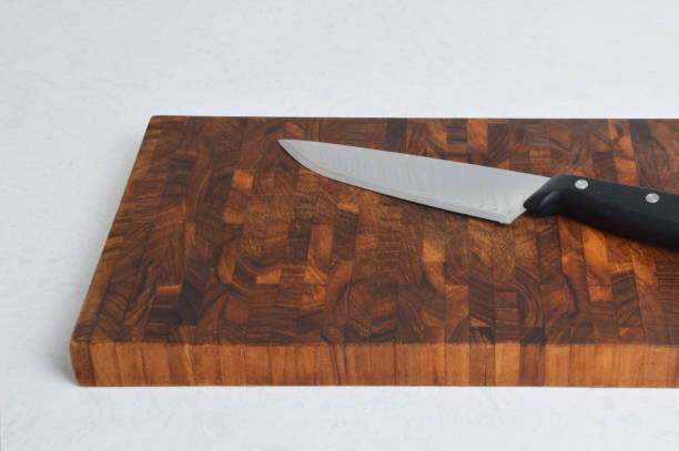 istock Old Cutting Board and Kitchen Knife on White Background 1181464543