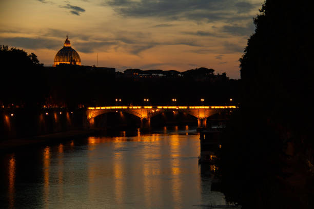Scenic view on St. Peter's Basilica from the bridge of the Holy Angel at sunset