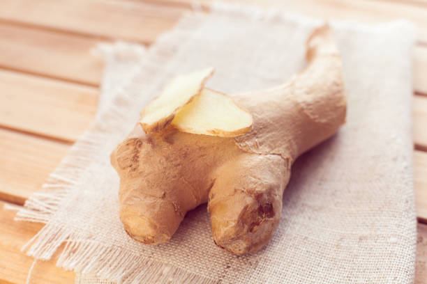 istock ginger and ginger slices on a wooden background 1181465597