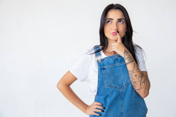 istock Thoughtful young woman looking up 1181465902