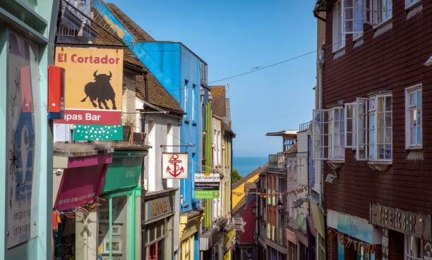 Building facade: the multicoloured exterior of a row of shops Building facade: the multicoloured exterior of a row of shops in Folkestone, Kent, UK berk stock pictures, royalty-free photos & images