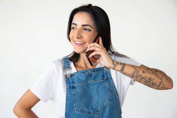 istock Smiling young woman talking on smartphone 1181468777