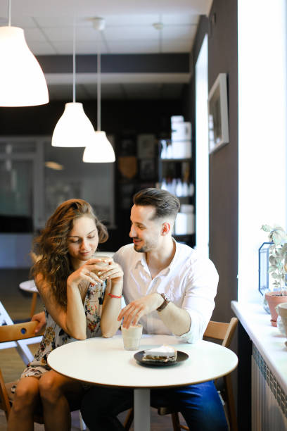 istock Young married nice couple sitting at cafe and hugging 1181470147