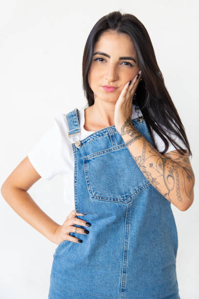 istock Thoughtful young woman holding hand on cheek 1181470628