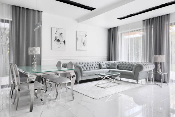 Charming gray living room Charming and luxury living room in gray and white with glass table and glamour style corner sofa charming photos stock pictures, royalty-free photos & images