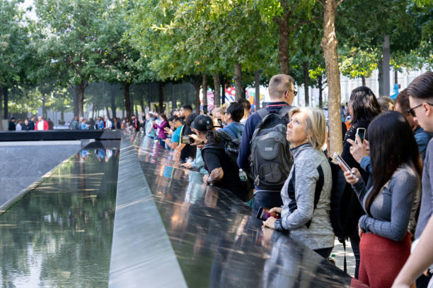 Memorial Pool at Ground Zero in Lower Manhattan, NYC New York, United States of America - September 19, 2019: People standing at the north pool of the World Trade Center Ground Zero Memorial in Lower Manhattan. to the struggle against world terrorism statue photos stock pictures, royalty-free photos & images