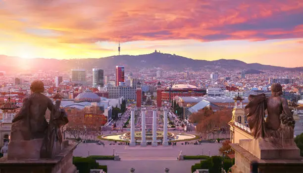 Sunset over Barcelona Spain Square of Spain Evening urban panorama with statue top view.
