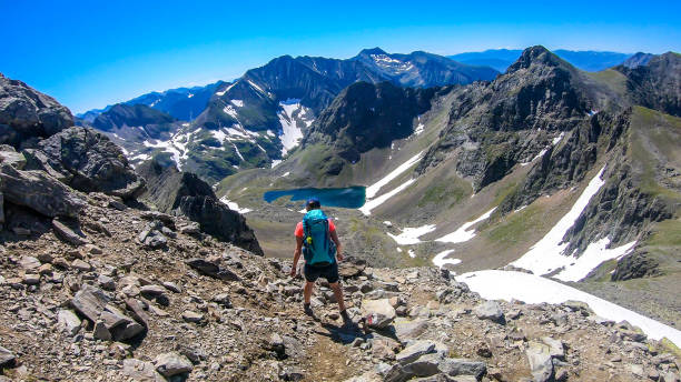 istock Schladming - A girl with a big backpack going towards a lake 1181480171