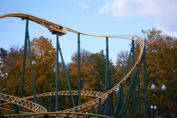 istock Close-up modern Cool roller coaster ride against amusement park and blue sky and white clouds, fun festival 1181480257