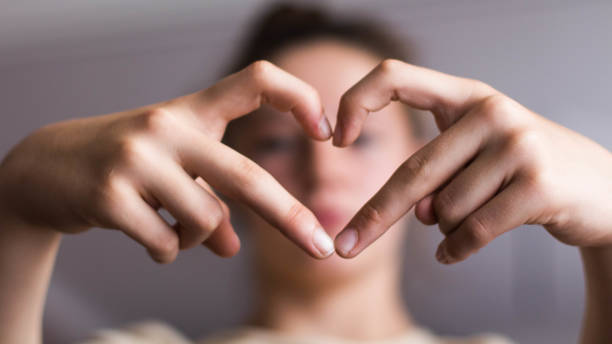 istock A girl forms a heart with her hands 1181483244