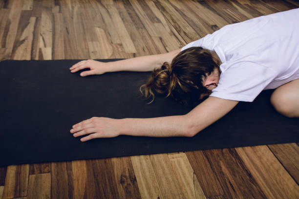 istock Young woman practicing yoga in home. 1181484485