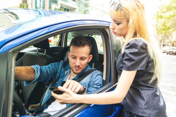 istock Young woman asking information for a driver. 1181487958