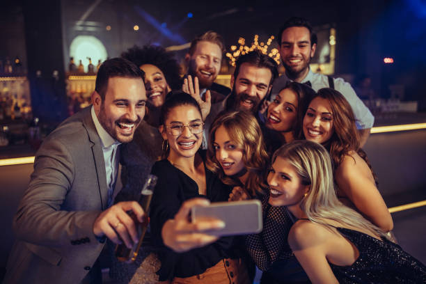 We'll be our own paparazzi Group of friends taking a selfie at the nightclub office parties stock pictures, royalty-free photos & images