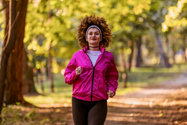 istock Young female athlete jogging in forest. Jogger doing morning physical training. 1181492810
