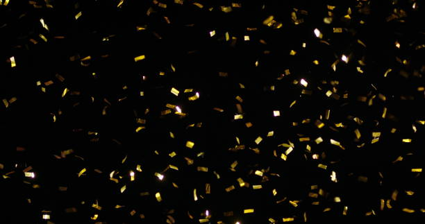 Confetti Isolated on Black Background Confetti fired in the air during a party. Only confetti on black background of the night. Falling metallic glitter foil confetti multicolor in black background. slow motion photos stock pictures, royalty-free photos & images