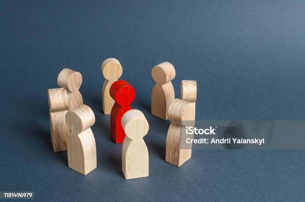 Red Human Figure Surrounded By A Circle Of People Leader Boss And Leadership Cooperation And Teamwork Outcast Hated Opponent Criminal Conviction Discrimination And Violence Bullying Stock Photo - Download Image Now