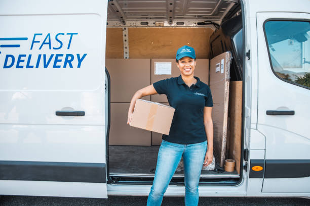 istock Mixed race woman working at a warehouse and holding a package 1181499437