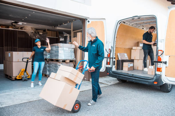 istock Small group of people unloading the packages from the delivery van full 1181499449