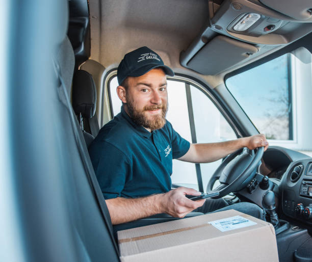 istock Mature Caucasian man using smart phone inside the delivery van before delivering packages 1181499528