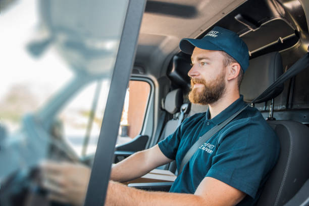 Mature Caucasian man driving the delivery van Mature Caucasian man driving the delivery van driver occupation stock pictures, royalty-free photos & images