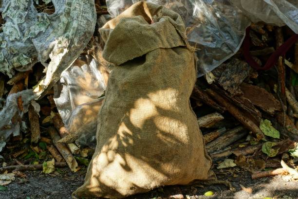 istock one full brown burlap bag on the street 1181499736