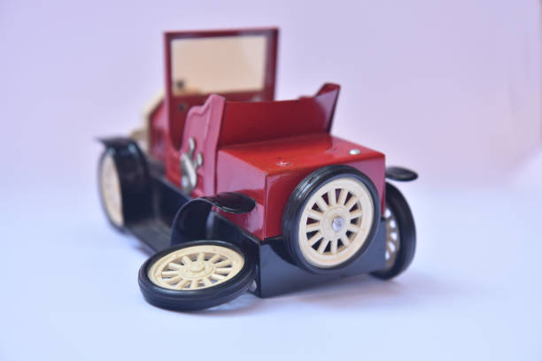 istock Small red antique toy car with a broken wheel 1181500111