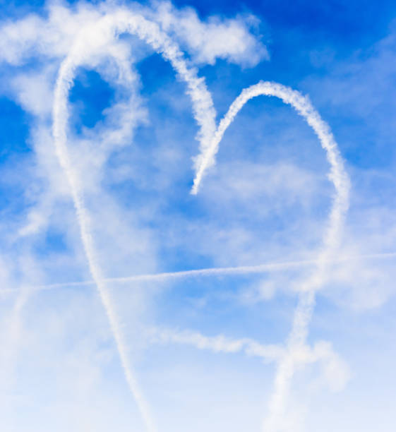 istock Heart shape with cupids arrow written in the sky with smoke 1181503662