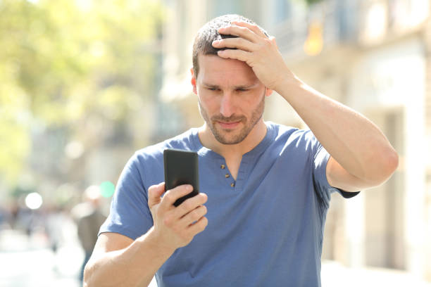 istock Confused man complaining after mistake checking phone 1181503970