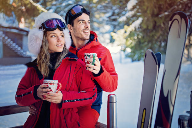 istock Young couple is drinking hot tea after skiing 1181505407