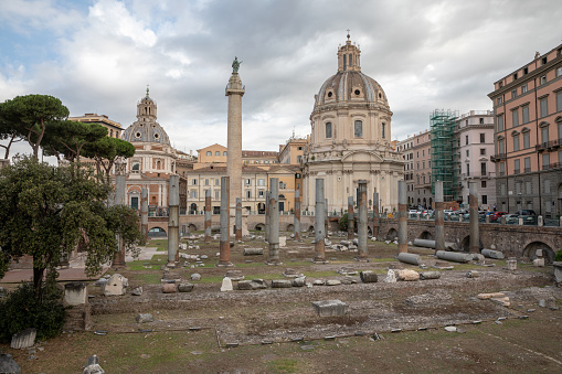 Rome, Italy - June 23, 2018: Panoramic view of Trajan's Forum and Column in Rome, far away the Church of the Most Holy Name of Mary. Summer day and blue sky