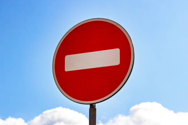 istock Red and white Do not enter sign on blue sky background 1181507375