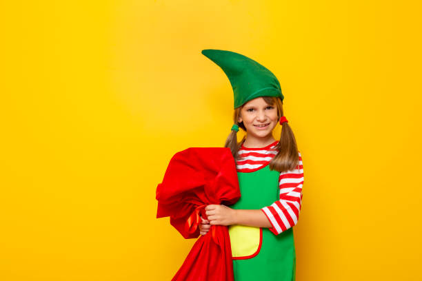istock Christmas elf holding sack of presents 1181508264