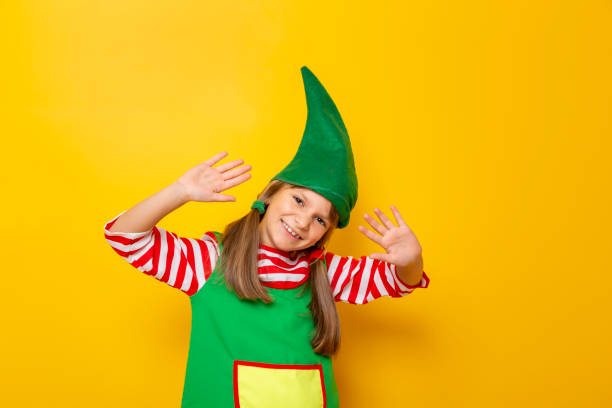 istock Child in Christmas elf costume waving 1181508337