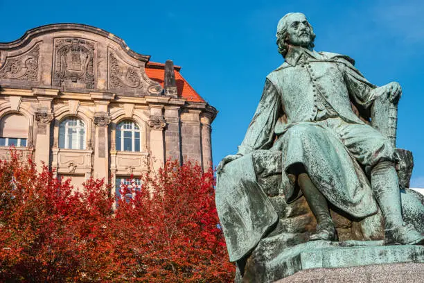 Photo of Statue of great scientist Otto Guericke in Magdeburg in red and golden Autumn colors, Germany