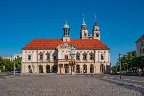Panoramic view at City Hall (Rathaus), Golden Equestrian statue of Magdeburger Reiter and Alter Markt Square in Magdeburg at blue sky and sunny day, Germany, summer time