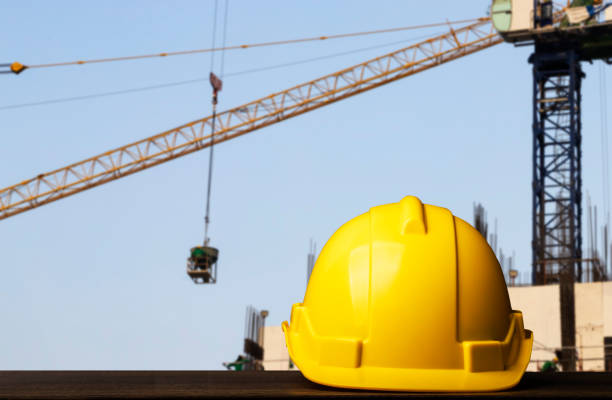 istock helmet in construction site and construction site worker background, safety first concept. 1181513437