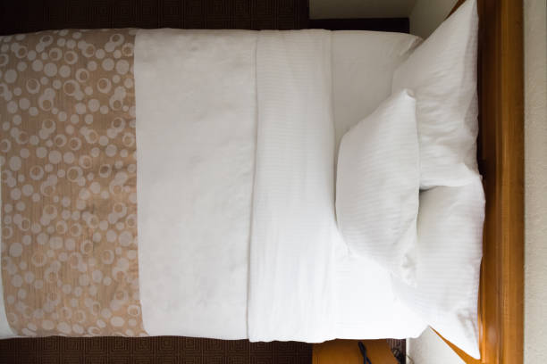 istock Clean, made bed with white linens and pillows 1181515267