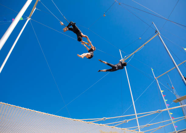 istock Three trapeze artists performing the show in the sky 1181519063
