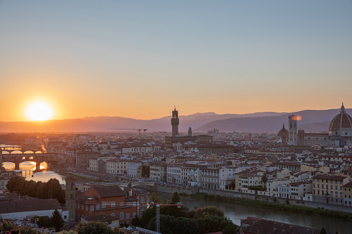 Panoramic view of Florence city with Cattedrale di Santa Maria del Fiore and Palazzo Vecchio from Piazzale Michelangelo (Michelangelo Square). Summer sunny day and dramatic blue sky