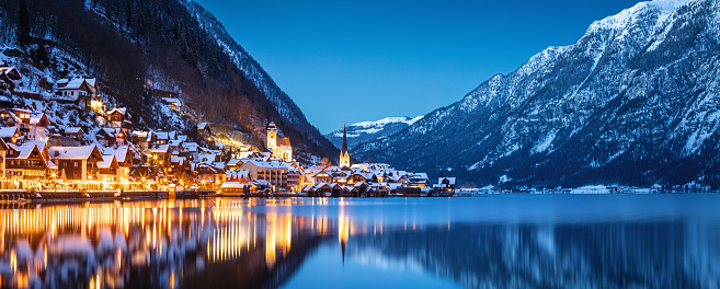 Tranquil winter evening in idyllic snowcapped Austrian village Hallstatt.