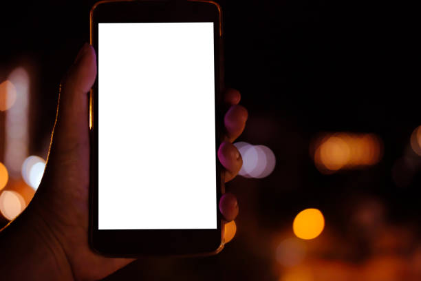 istock hand holding mobile smart phone with bokeh night light 1181522369