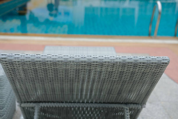 istock wicker rattan pool sun bed deckchair at swimming pool 1181522373