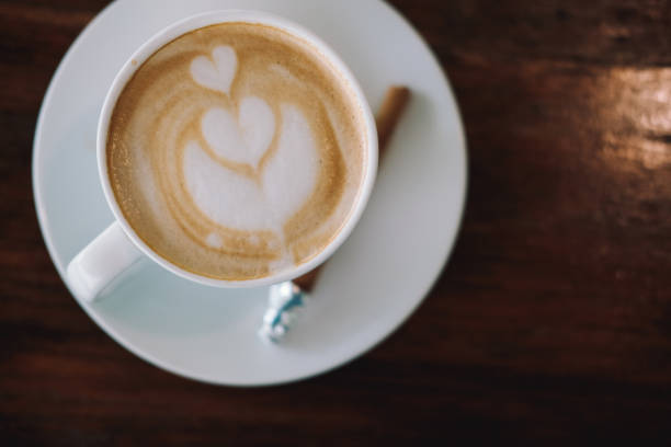 istock hot cappuccino latte coffee on wood table. 1181522551