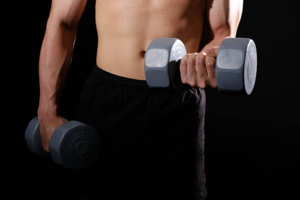 istock athletic muscular bodybuilder man with naked torso six pack abs working out with dumbbell. fitness  exercise concept 1181522567