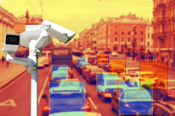 istock The concept of video surveillance and security technologies. Surveillance camera on the background of the city road with cars. Definition zone. Tint 1181523816