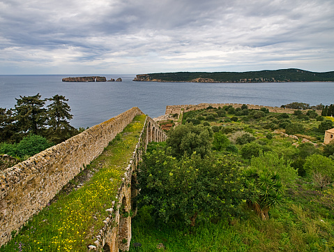 View from  castle walls to sea and islands under dramatic cloudy sky. Navarino, Peloponnese, Greece.